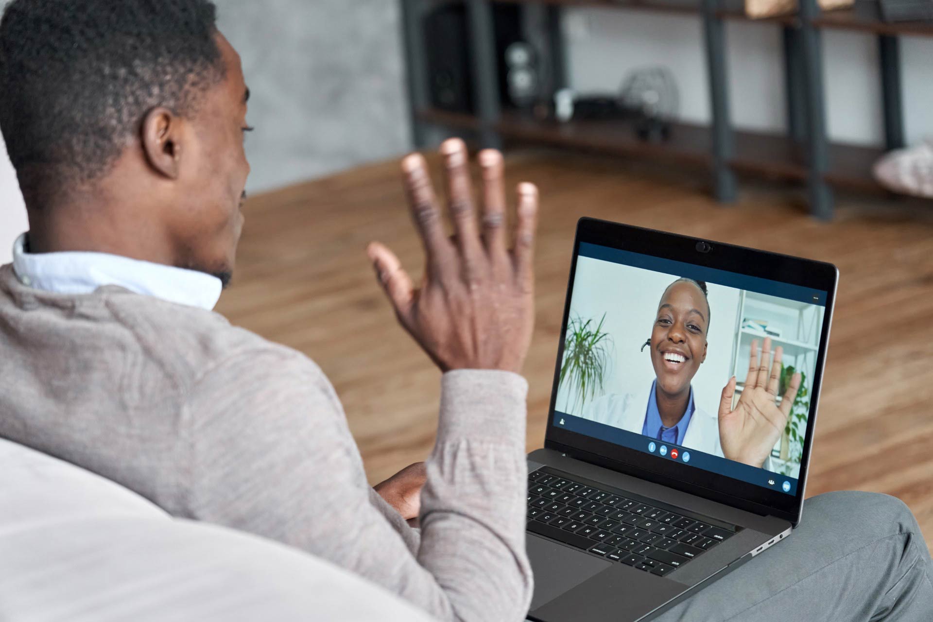 A patient meeting with a doctor on a computer